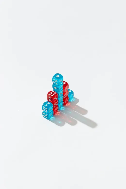 A small tower of red and blue dice on a white background